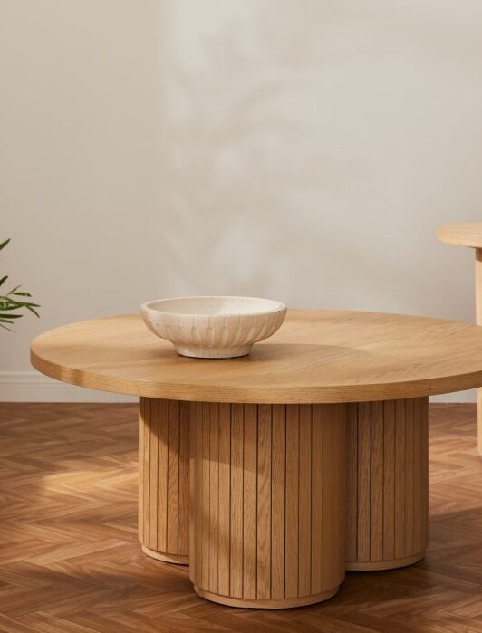 A circular wooden coffee table from Joybird.