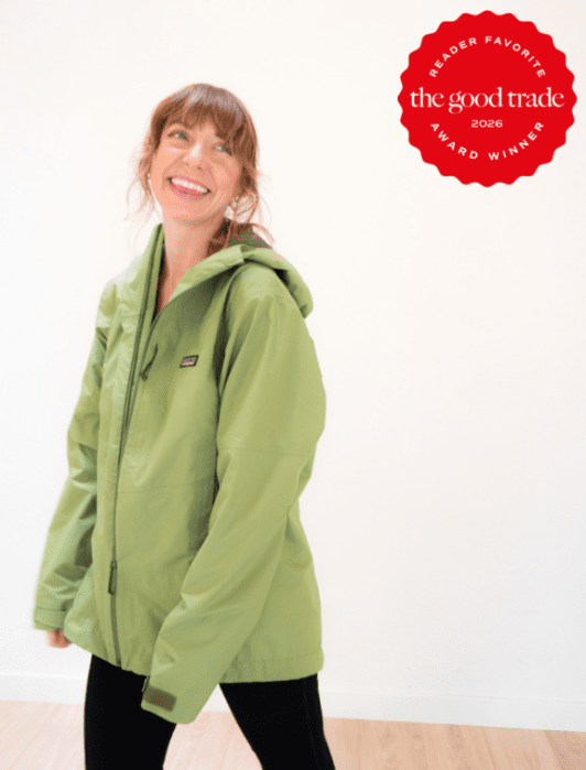 A smiling woman in a light green Patagonia jacket stands indoors; a red badge reads "Reader Favorite The Good Trade Award Winner 2026.