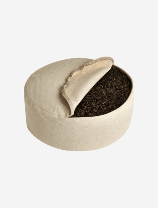 Renoo meditation pillow, opened, showing the buckwheat fill.