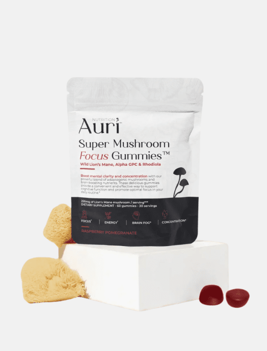 A pouch of Auri Super Mushroom Focus Gummies, featuring a lion’s mane mushroom and two dark red gummy supplements on a white pedestal.