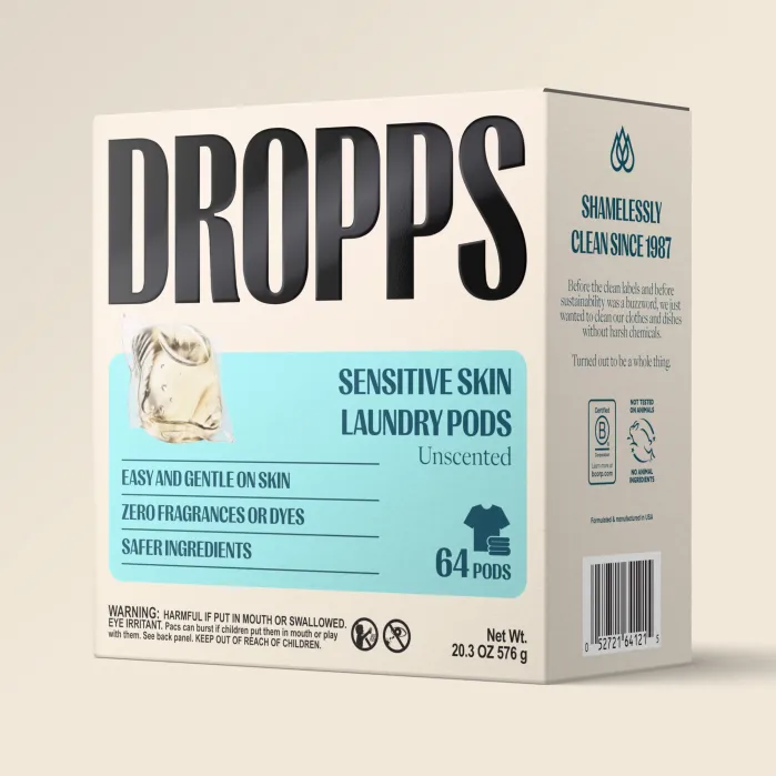 Box of Dropps Sensitive Skin Unscented Laundry Pods, 64 count, with product claims including no fragrances or dyes and safer ingredients, designed for easy and gentle use on skin.