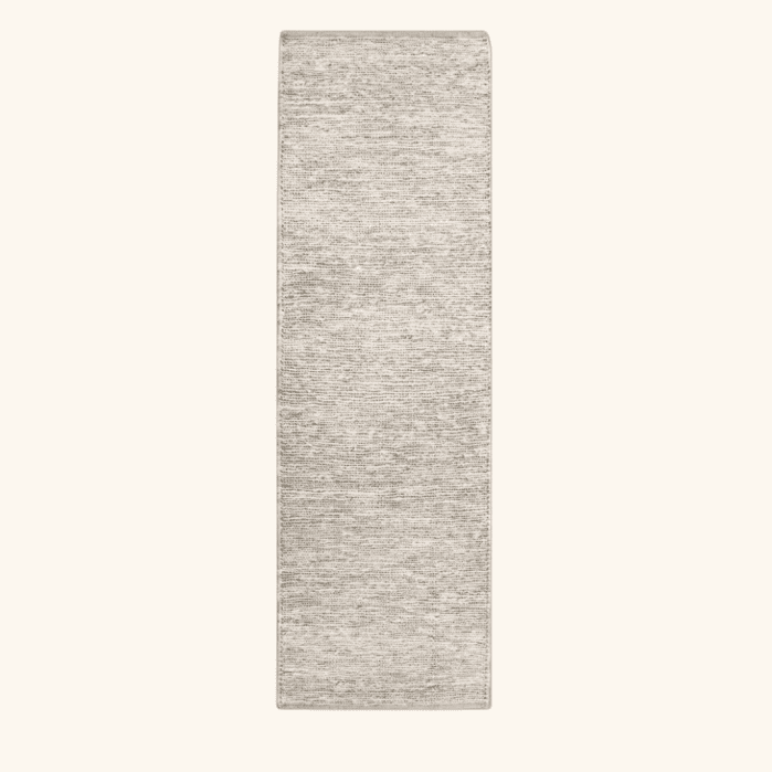 Rectangular runner rug with a neutral, textured weave.