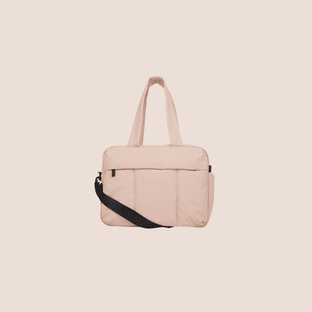 Light pink rectangular tote bag with a black shoulder strap.