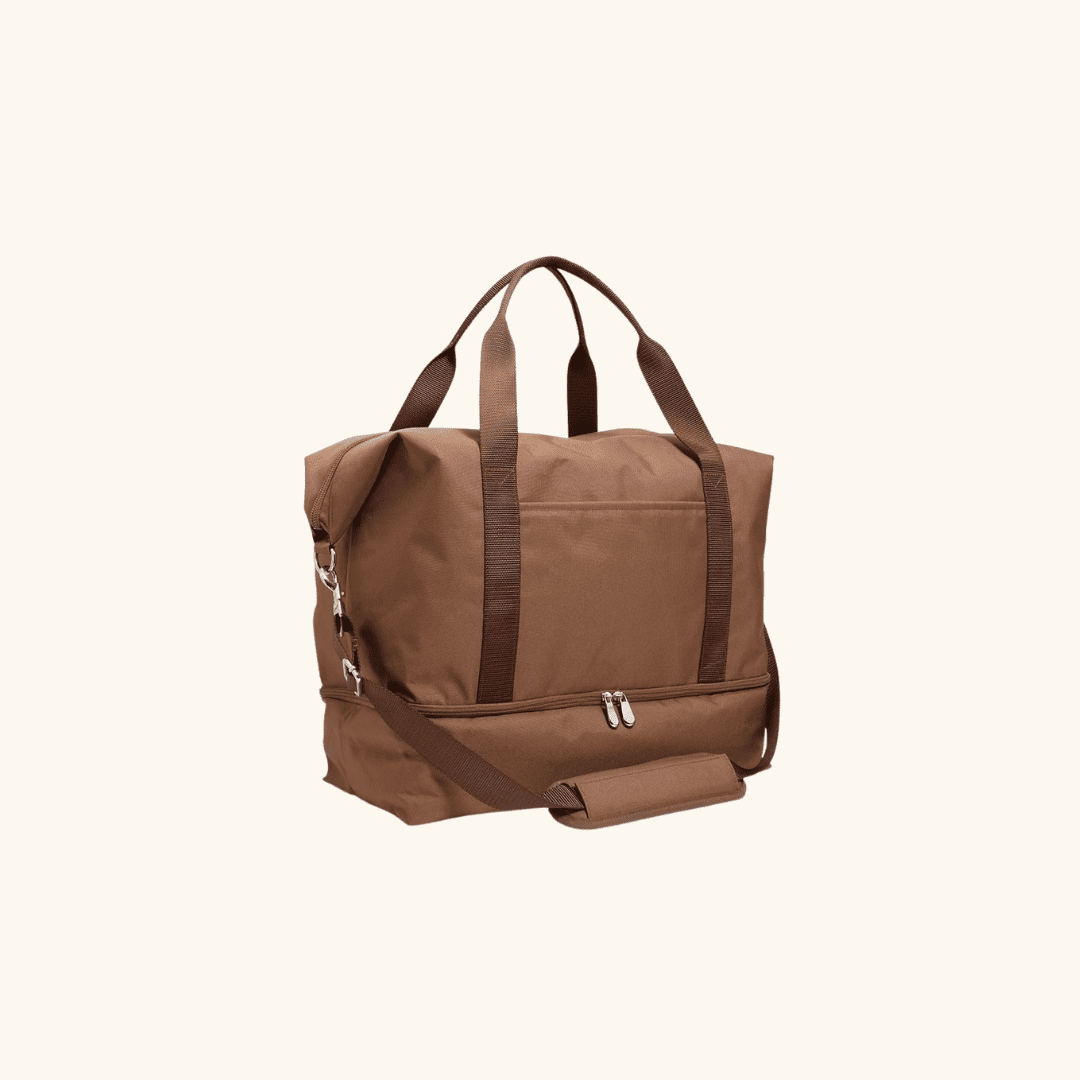 Brown duffel bag with a separate zippered bottom compartment and a detachable shoulder strap.