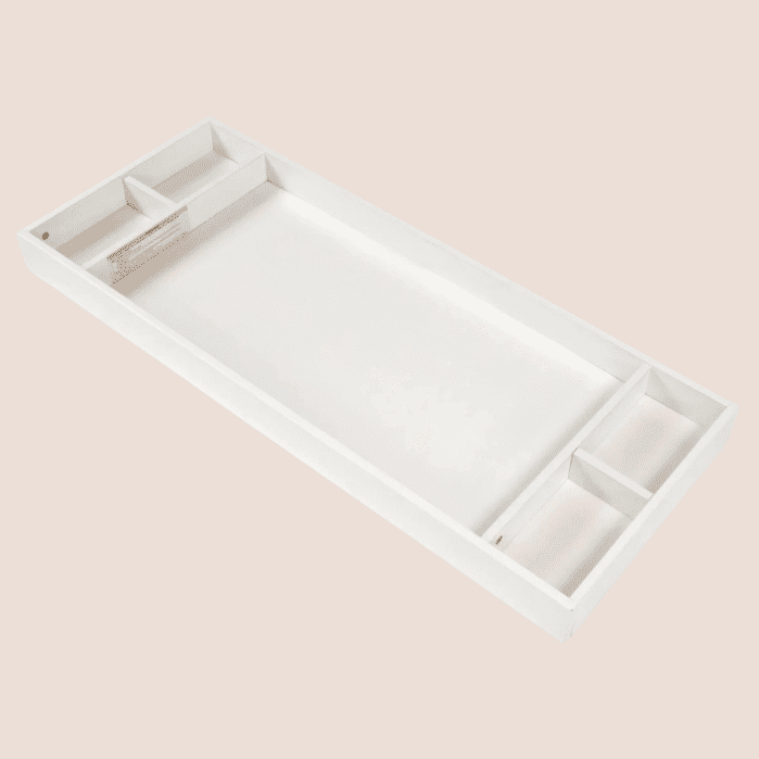 Rectangular white changing table topper with storage compartments at both ends.