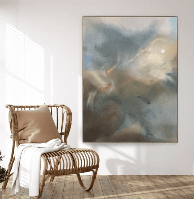 A framed abstract painting and a rattan chair. 