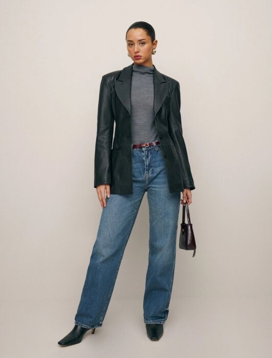 A model wearing a leather blazer from Reformation.