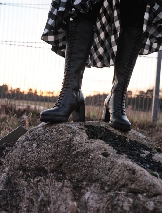 A model wearing sustainable boots from Bhava