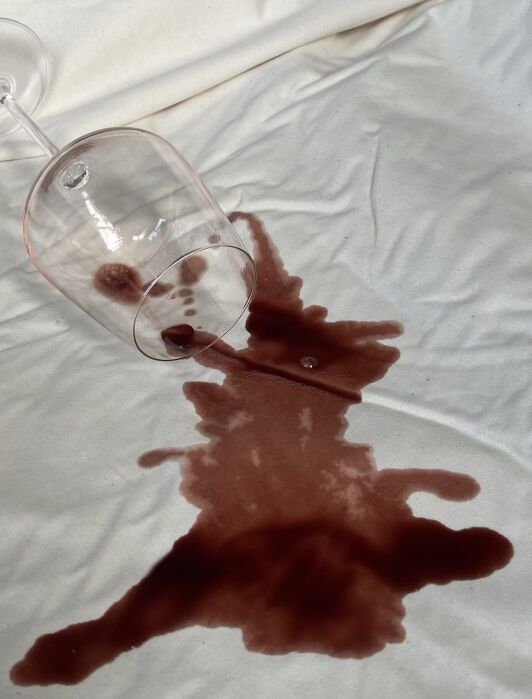 A wine spill on the mattress protector from Happsy