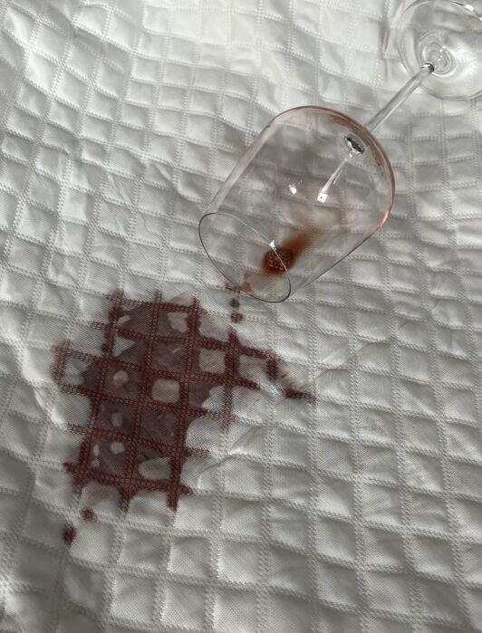 A wine spill on the mattress protector from Silk & Snow