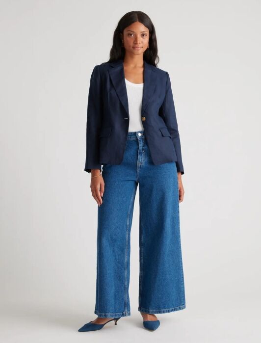 A model wearing a blue blazer from Quince.