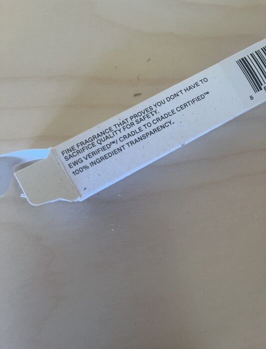 Text on a cardboard box reads: "Fine fragrance that proves you don't have to sacrifice quality for safety. Engineered for Cradle-to-Cradle Certified™ 100% ingredient transparency.