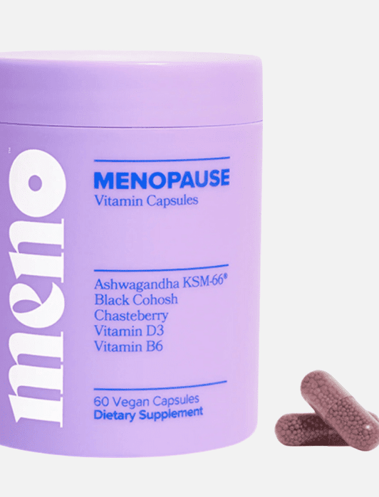 Purple container of Meno Menopause Vitamin Capsules with a list of ingredients. Two capsules are shown next to the container. Label indicates 60 vegan capsules for dietary supplement.