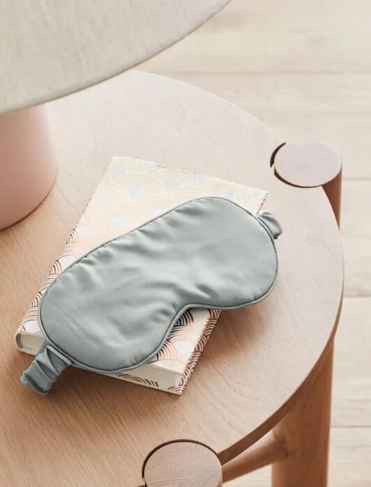 An Ettitude sleep mask on a table.