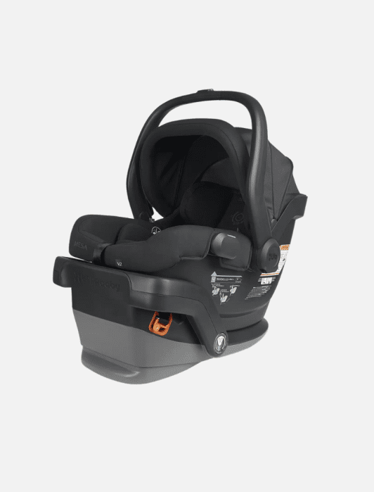 Black infant car seat with a carrying handle on a gray base, featuring safety instruction labels and harness system.