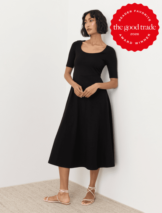 Woman stands against a white wall wearing a black midi dress and beige lace-up sandals. A red "The Good Trade 2026 Reader Favorite Award Winner" badge appears in the top right corner.