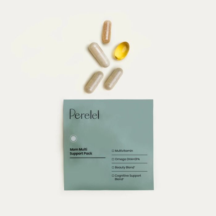 A green packet labeled "Perelel Mom Multi Support Pack" lies below five supplement capsules of varying colors and shapes arranged in an arc.