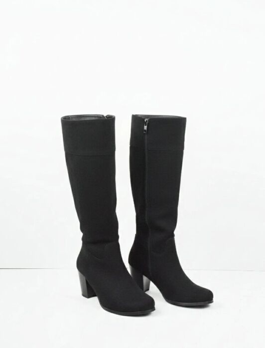 A pair of black knee-high boots with block heels and side zippers, standing upright against a plain white background.