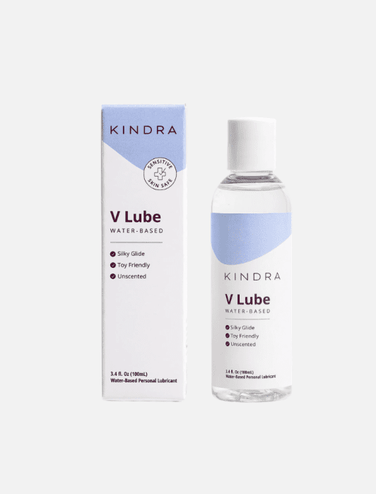 A bottle and box of Kindra V Lube water-based personal lubricant, featuring labels that highlight it as silky, toy friendly, and unscented.