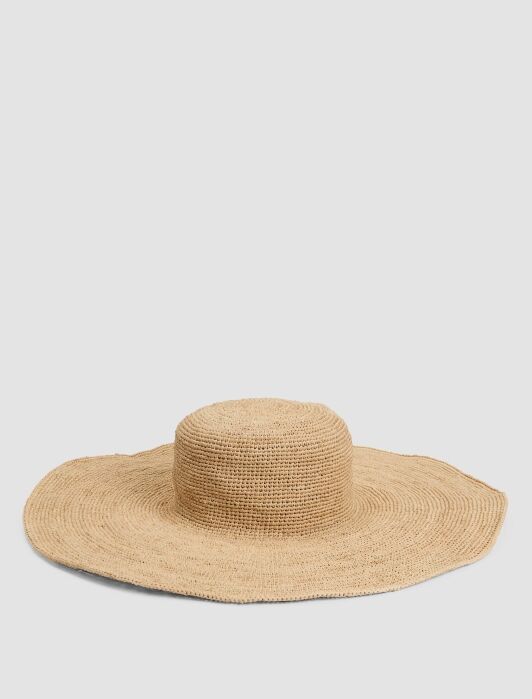 Wide-brimmed natural straw hat with a round crown, displayed on a plain white background.