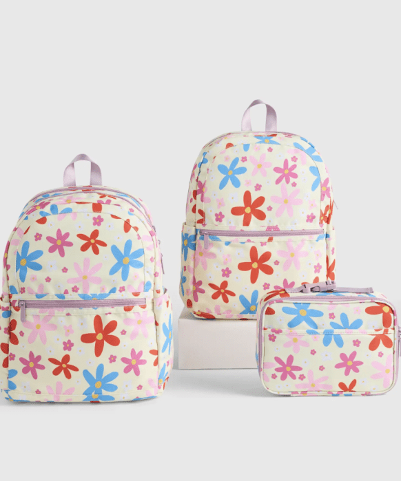 Three bags with a colorful floral pattern: two backpacks of different sizes and a small matching pouch, displayed on a plain background.