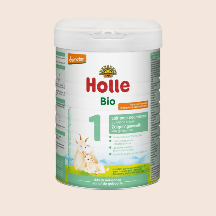 Container of Holle Bio infant formula stage 1, with a white lid, green and yellow labeling, and illustrations of a goat and kid on the front.