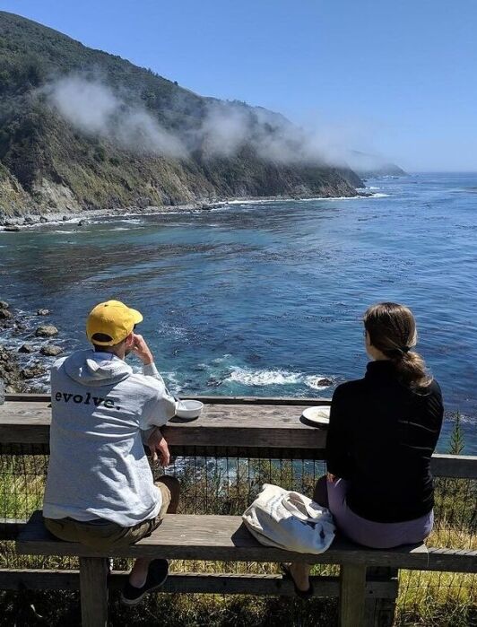 A couple looking out to the ocean at Esalen Institute.