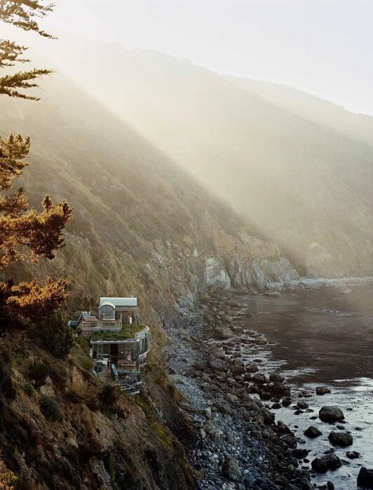 A landscape look of the hills, ocean, and Esalan Retreat. 
