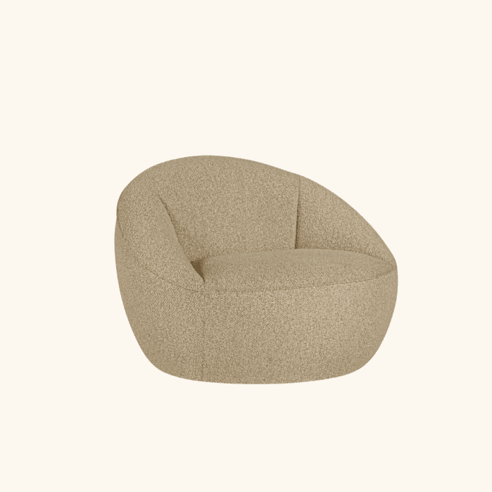 A rounded, beige upholstered lounge chair with a low, wide seat and curved backrest, set against a plain light background.